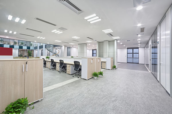 wide office space with overhead lighting fixtures